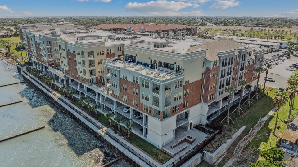 an aerial view of the apartment complex near the water at The  Alexa