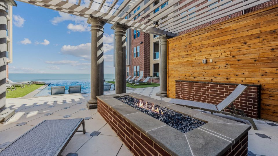a fire pit on the patio with a view of the ocean at The  Alexa