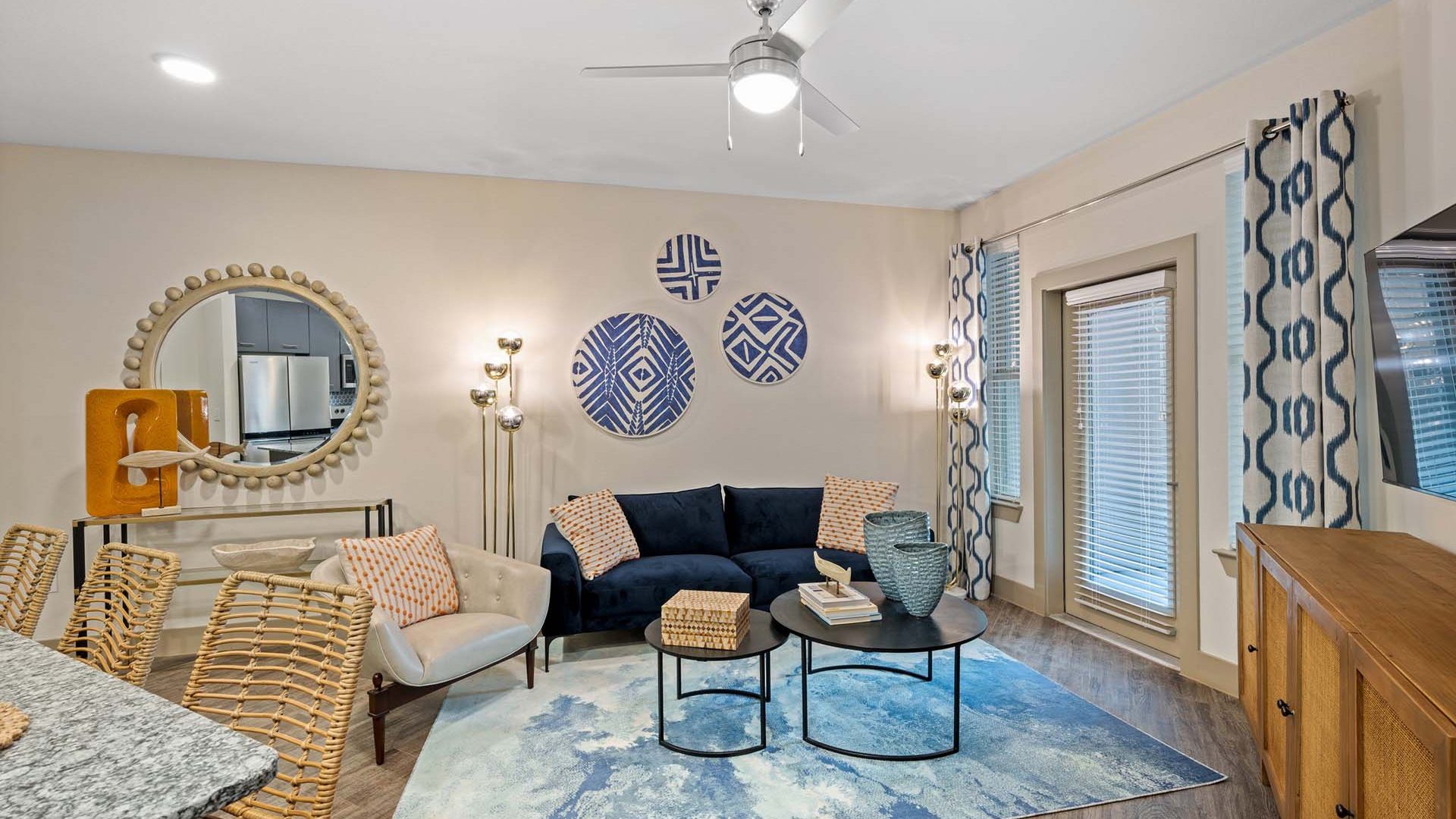 a living room with a blue ceiling fan and blue walls at The  Alexa